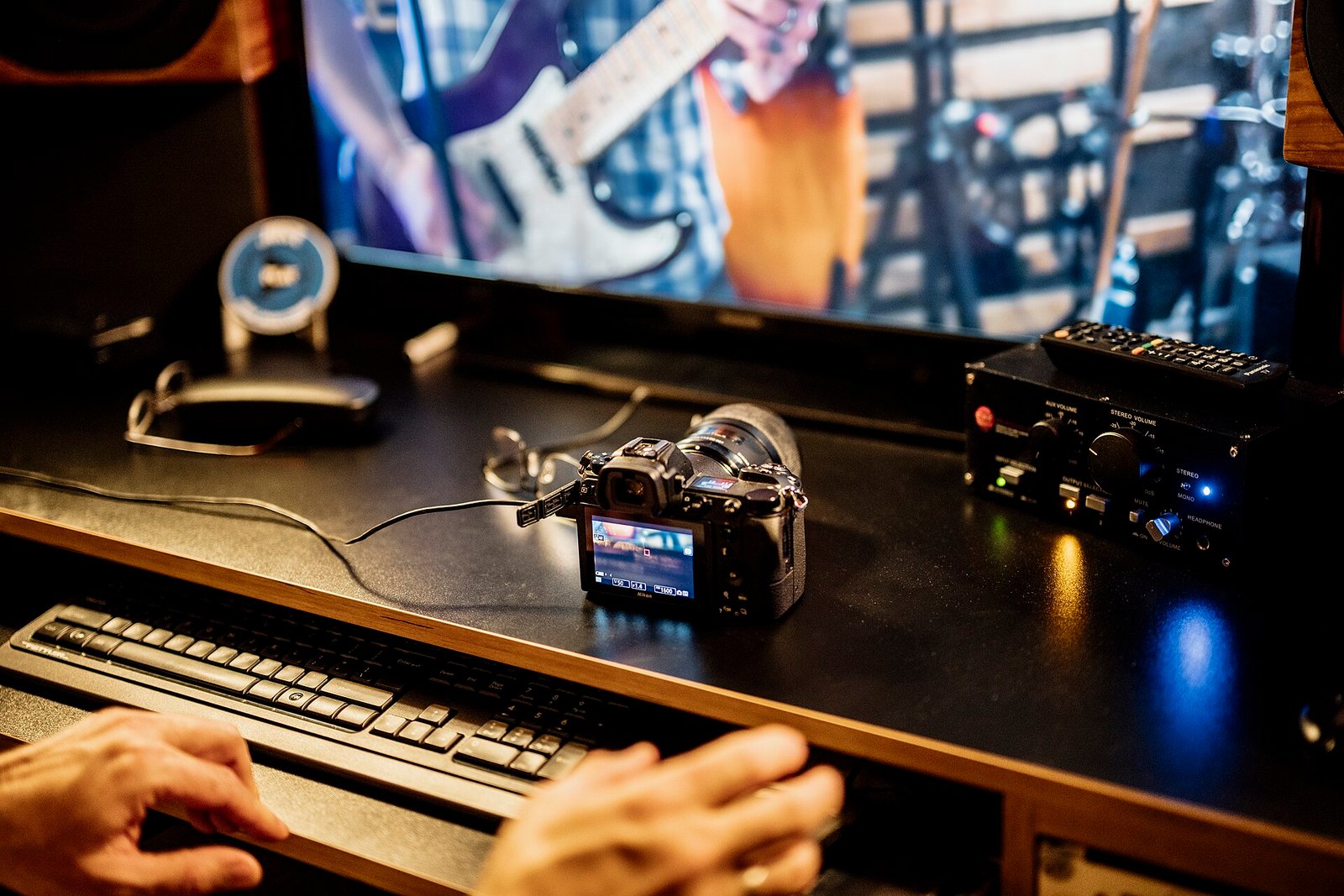 Recording session takes place with camera and computer in music studio