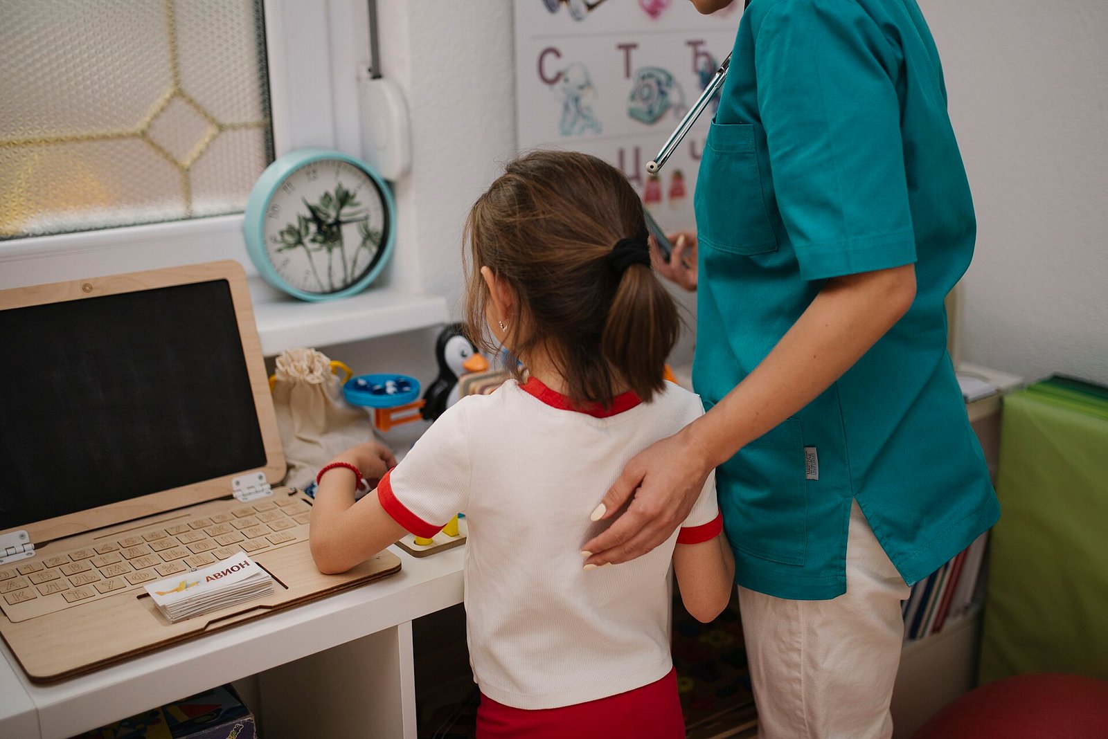 Child in medical consultation with caregiver at a home office